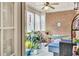 Relaxing sunroom with brick wall, plants, a hammock and a ceiling fan at 498 Townsend St, Grayson, GA 30017