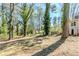Large, wooded backyard with mature trees and house in background at 1542 Columbia Dr, Decatur, GA 30032