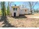 Back of house, showing a brick exterior, door, and grassy yard at 1542 Columbia Dr, Decatur, GA 30032