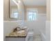 Bright bathroom features a granite countertop, white tile, and window at 1542 Columbia Dr, Decatur, GA 30032