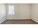Bedroom with a neutral color scheme, window, and plush carpeting at 1542 Columbia Dr, Decatur, GA 30032