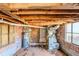Exposed crawl space with water heater, duct work, brick foundation, and two windows at 1542 Columbia Dr, Decatur, GA 30032