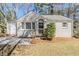 Charming single-story home featuring a painted brick facade, inviting front porch, and mature trees at 1542 Columbia Dr, Decatur, GA 30032