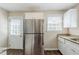 Updated kitchen with stainless steel refrigerator, granite countertops, and ample cabinet space at 1542 Columbia Dr, Decatur, GA 30032