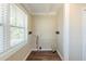 Small laundry room with wainscotting, wood floor, and bright window at 1542 Columbia Dr, Decatur, GA 30032