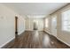 Spacious living room with new wood flooring, fresh paint, and a view into the kitchen at 1542 Columbia Dr, Decatur, GA 30032