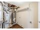 The basement utility area has wood-look flooring, storage shelving, and exposed ductwork and plumbing at 1908 Sailcloth St, Lithonia, GA 30058