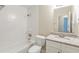 Bright bathroom features a shower-tub combo with white tiled walls, granite countertops and a large mirror at 1908 Sailcloth St, Lithonia, GA 30058