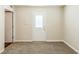 Neutral room with carpeted floors, a glass-paned exterior door, and an interior door to another area at 1908 Sailcloth St, Lithonia, GA 30058