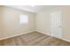 Neutral bedroom with carpet, a window with blinds, and an interior door to another area of the home at 1908 Sailcloth St, Lithonia, GA 30058