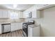 Modern kitchen featuring sleek white cabinets, stainless steel appliances, and granite countertops at 1908 Sailcloth St, Lithonia, GA 30058