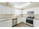 Bright kitchen featuring granite countertops, stainless steel appliances, and white cabinetry at 1908 Sailcloth St, Lithonia, GA 30058