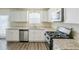 Bright kitchen featuring granite countertops, stainless steel appliances, and white cabinetry at 1908 Sailcloth St, Lithonia, GA 30058