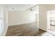 Open living room with view into the kitchen, large bright windows and laminate flooring at 1908 Sailcloth St, Lithonia, GA 30058