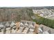 Aerial view of the homes in a neighborhood with lots of trees and a small pond at 2785 Maple Park Pl, Cumming, GA 30041