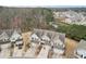 Aerial view showcasing townhomes, garages, and manicured lawns in a well-planned community at 2785 Maple Park Pl, Cumming, GA 30041