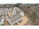 Aerial view of a community's layout and proximity to a wooded area, showing neighborhood streets at 2785 Maple Park Pl, Cumming, GA 30041