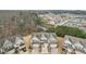 Aerial view of townhomes showcasing well-maintained exteriors and a community surrounded by lush greenery at 2785 Maple Park Pl, Cumming, GA 30041