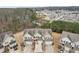 Aerial view of townhomes with garages and green surroundings in a neighborhood setting at 2785 Maple Park Pl, Cumming, GA 30041