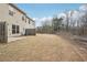 Expansive backyard featuring grass with trees and partial fencing at 2785 Maple Park Pl, Cumming, GA 30041