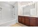 Bright bathroom features a double vanity and shower-tub combination at 2785 Maple Park Pl, Cumming, GA 30041