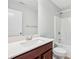Bright bathroom features a vanity with dark wood cabinets and a shower-tub combination at 2785 Maple Park Pl, Cumming, GA 30041