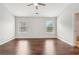 Spacious bedroom with wood floors, two windows and overhead fan at 2785 Maple Park Pl, Cumming, GA 30041