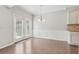 Dining area with hardwood floors and large windowed door leading to the backyard at 2785 Maple Park Pl, Cumming, GA 30041