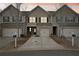 Beautiful townhome with one car garage, complemented by well-maintained landscaping at 2785 Maple Park Pl, Cumming, GA 30041