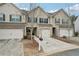 Charming townhome featuring a one car garage and inviting brick and siding exterior at 2785 Maple Park Pl, Cumming, GA 30041