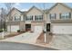 Beautiful townhome with one car garage, complemented by well-maintained landscaping at 2785 Maple Park Pl, Cumming, GA 30041