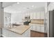 Bright kitchen featuring granite countertops, stainless steel appliances, and white cabinetry at 2785 Maple Park Pl, Cumming, GA 30041