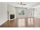 Bright living room with hardwood floors, a fireplace, and doors to the backyard at 2785 Maple Park Pl, Cumming, GA 30041