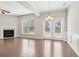 Living room features a fireplace, hardwood floors, large windows, and French doors at 2785 Maple Park Pl, Cumming, GA 30041