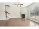 Bright living room featuring a fireplace, hardwood floors and a staircase at 2785 Maple Park Pl, Cumming, GA 30041