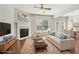 Bright living room features a fireplace, ceiling fan, and large windows with a view to the backyard at 2785 Maple Park Pl, Cumming, GA 30041