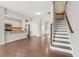 Open concept floorplan features a kitchen and dining area with hardwood floors and access to the staircase at 2785 Maple Park Pl, Cumming, GA 30041