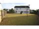 The backyard offers a sprawling grassy area, perfect for outdoor enjoyment and entertaining guests at 838 Roxholly Ln, Buford, GA 30518