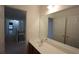 Bathroom featuring a single sink vanity and a view to the hallway at 838 Roxholly Ln, Buford, GA 30518