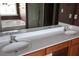 Bathroom showcasing a dual sink vanity, large mirror, and a separate bathtub at 838 Roxholly Ln, Buford, GA 30518