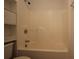 Bathroom features a shower and bathtub combo with white fixtures and tile flooring at 838 Roxholly Ln, Buford, GA 30518