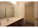Bathroom with single sink vanity, mirror and bath/shower combo and tiled floor at 838 Roxholly Ln, Buford, GA 30518