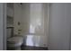 Bathroom features a shower and bathtub combo with white fixtures and tile flooring at 838 Roxholly Ln, Buford, GA 30518