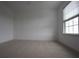 Neutral bedroom with a ceiling fan, plush carpet and natural light from the window at 838 Roxholly Ln, Buford, GA 30518