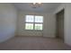 Bedroom featuring plush carpet, closet, and bright window at 838 Roxholly Ln, Buford, GA 30518