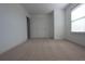 Carpeted bedroom with double closet, large window, and natural light at 838 Roxholly Ln, Buford, GA 30518