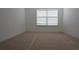 Carpeted bedroom with a window and bright white walls at 838 Roxholly Ln, Buford, GA 30518
