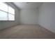 Cozy carpeted bedroom with large window and plenty of natural light at 838 Roxholly Ln, Buford, GA 30518