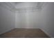 Spacious walk-in closet with wire shelving and neutral carpeting at 838 Roxholly Ln, Buford, GA 30518