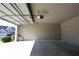 View of the home's large garage with an open door that can provide ample vehicle or storage space at 838 Roxholly Ln, Buford, GA 30518